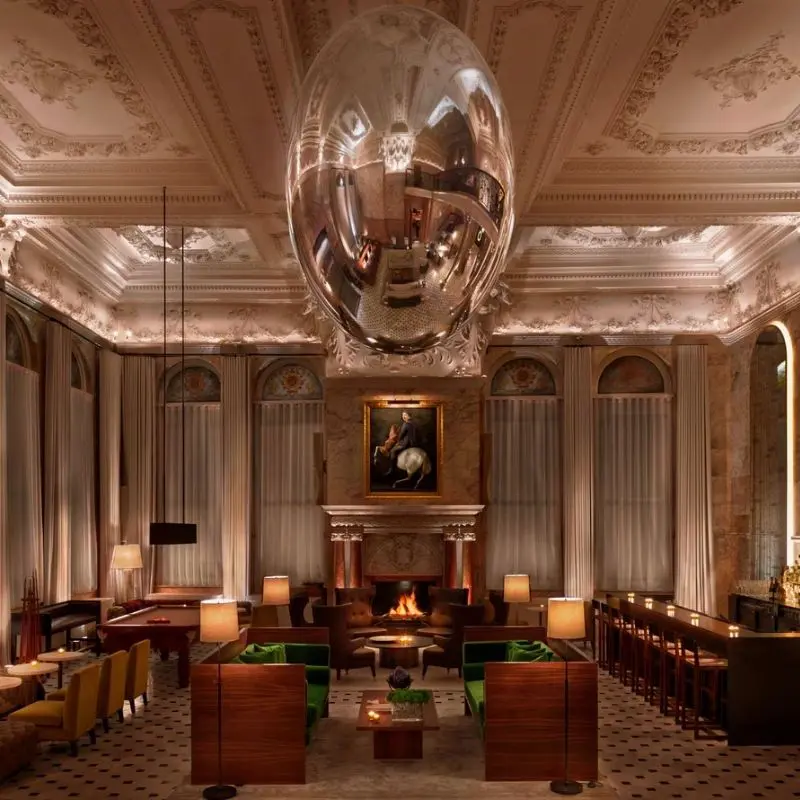 Lobby at The London Edition hotel Soho with oversized mirror ball sculpture