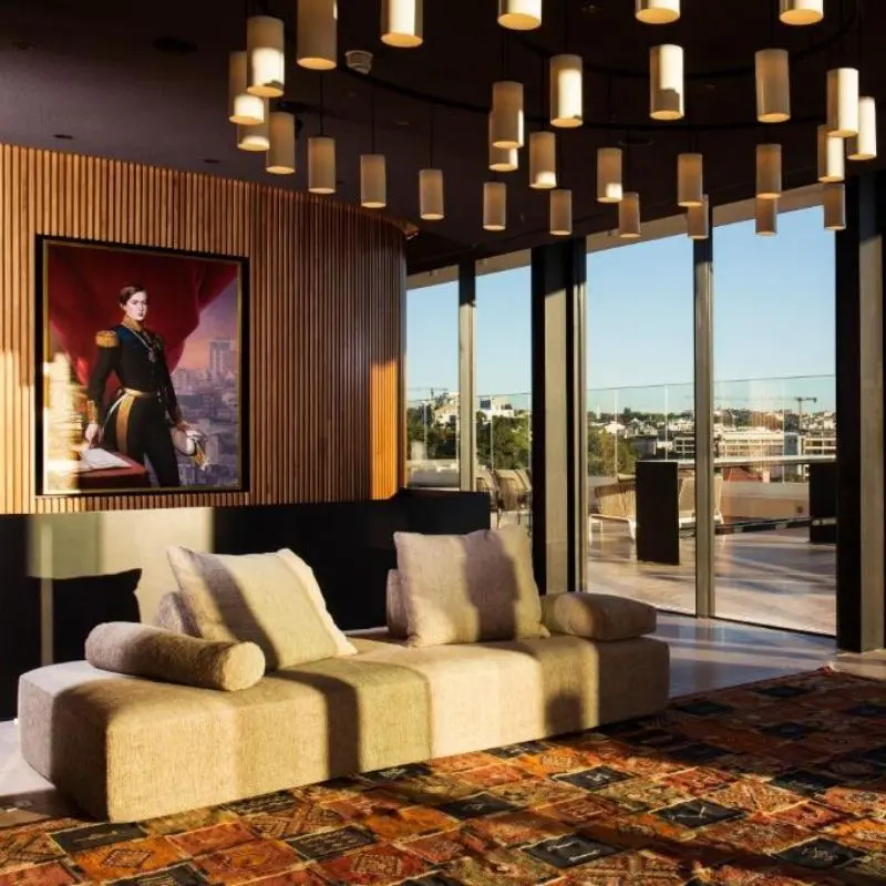 Rooftop terrace lounge at Memmo Príncipe Real Lisbon with timber ceiling and city views