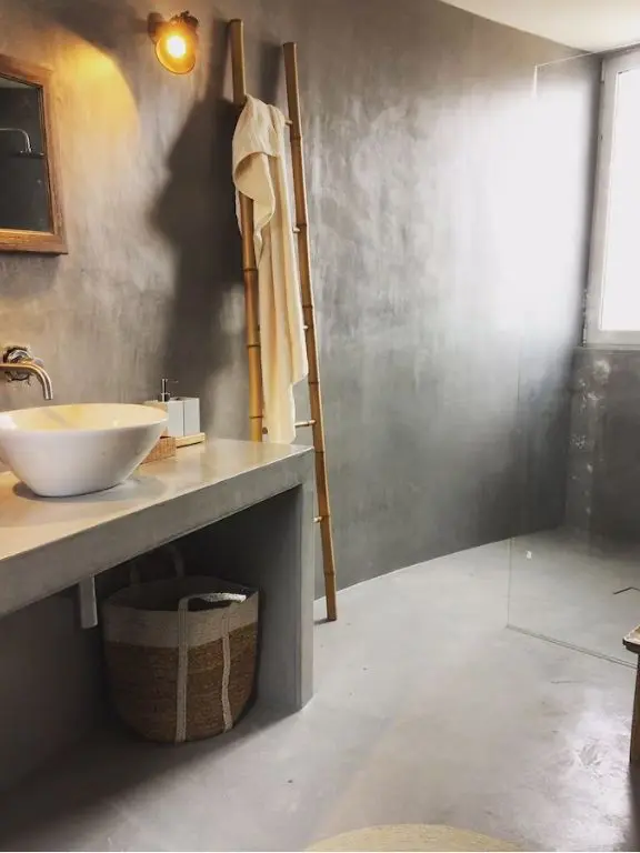 Concrete bathroom with basin sink and minimalist rustic finishes