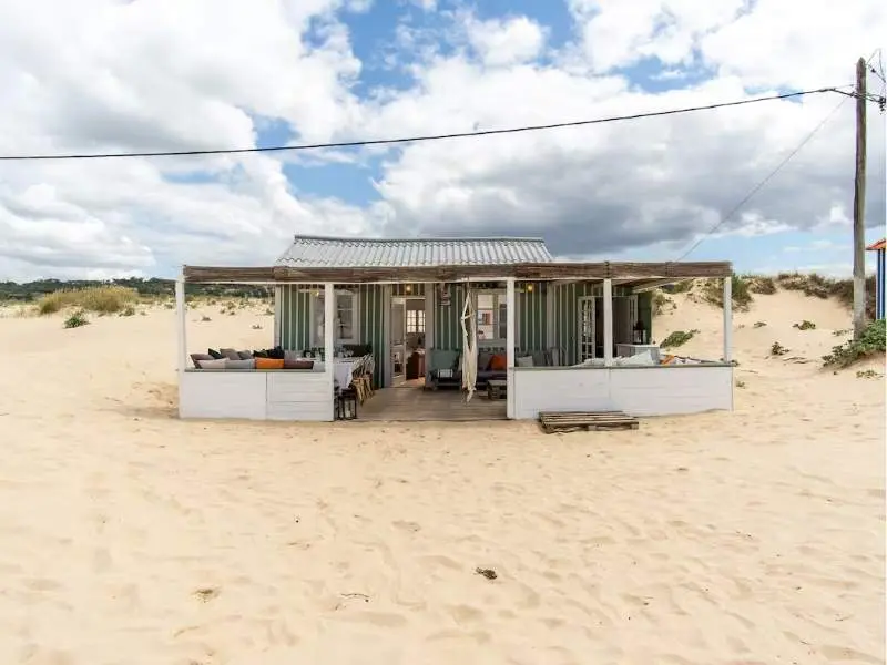 Beach cabana exterior set directly on the sand dunes by the shore