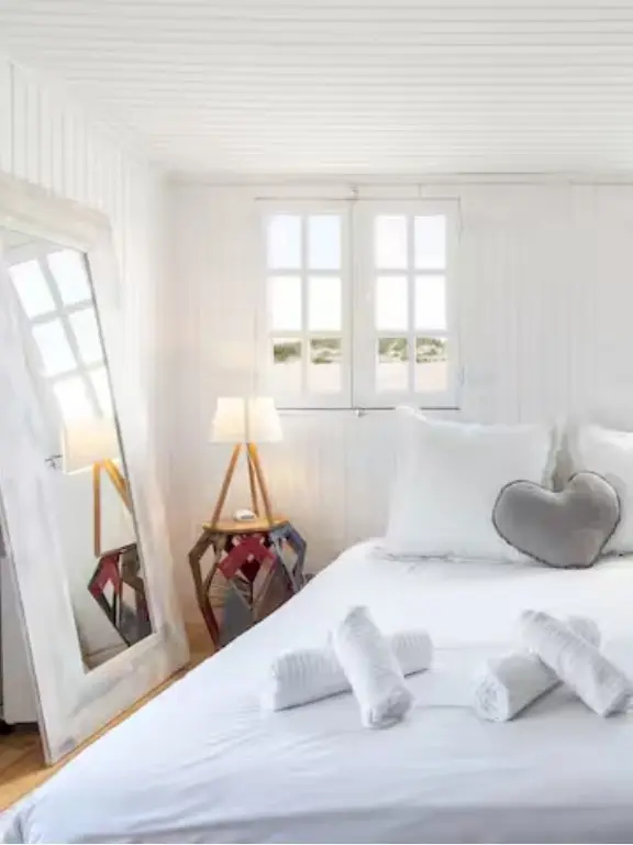 Whitewashed bedroom with soft linens and natural light