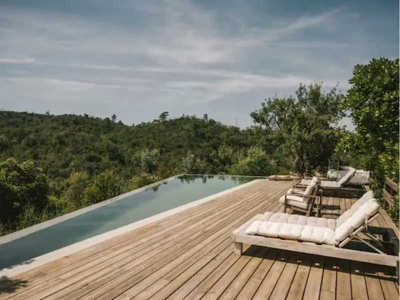 Infinity pool deck overlooking cork oak hills and countryside