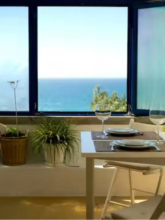 Dining table beside large windows overlooking the Atlantic