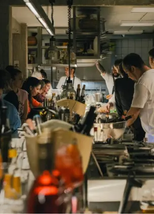 Open kitchen and busy dining room at Pharaoh, one of the most popular restaurants in Athens