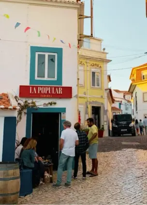 Streetfront exterior of La Popular restaurant on a cobbled village lane