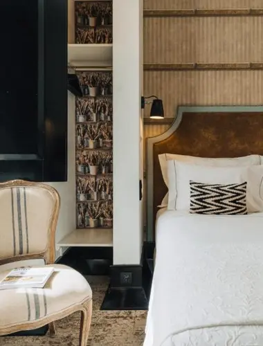 Guest room at Almalusa Baixa Chiado Lisbon with patterned headboard and flagstone floor Best Hotels in Chiado