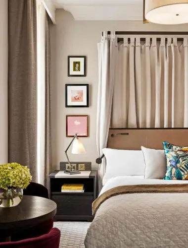 Guest room at Kimpton Fitzroy London with framed artwork and luxury bed
