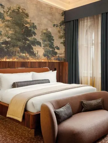 Guest room at St Pancras Autograph Collection London with forest mural wallpaper