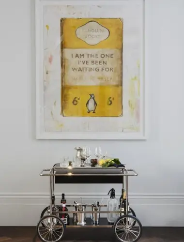 Bar trolley and Penguin book artwork at The Laslett hotels in Notting Hill London