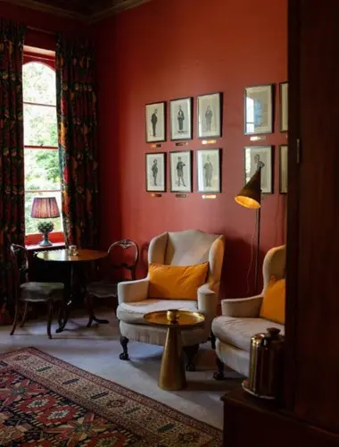 Sitting room at Portobello Hotel London with wingback chair and framed prints