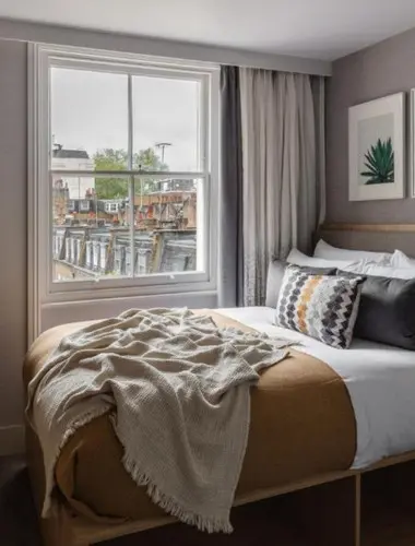 Bedroom at Inhabit Southwick Street London with natural materials and wool throw