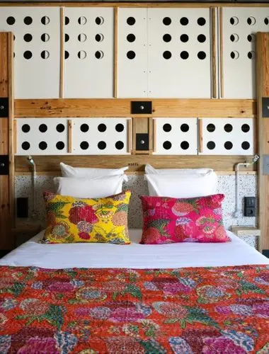 Guest room at JAM Hotel Lisbon Santos with hand-painted tile headboard and floral bedding