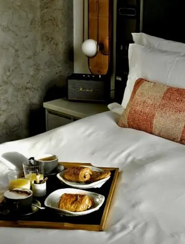 Guest room at Hart Shoreditch hotel with breakfast tray