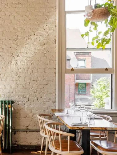 Exposed brick dining room at The Culpeper Shoreditch London
