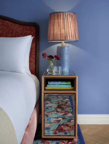 Guest room at Broadwick Soho London with blue walls and patterned lamp