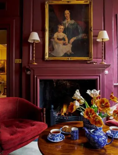 Fireplace and oil paintings in a guest room at Hazlitt's hotel Soho London