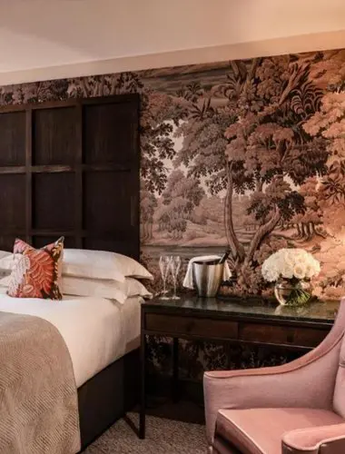 Guest room at The Bloomsbury Hotel London with floral mural wallpaper
