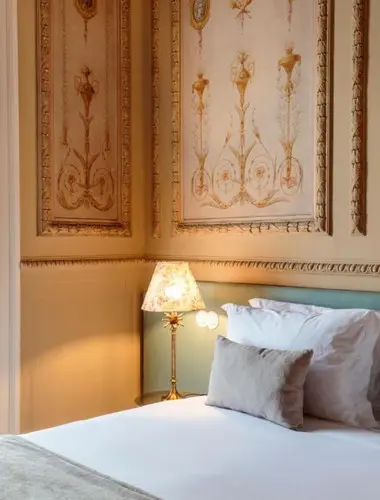 Guest suite at Dear Lisbon Valmor Palace with hand-painted wall panels and antique lamp