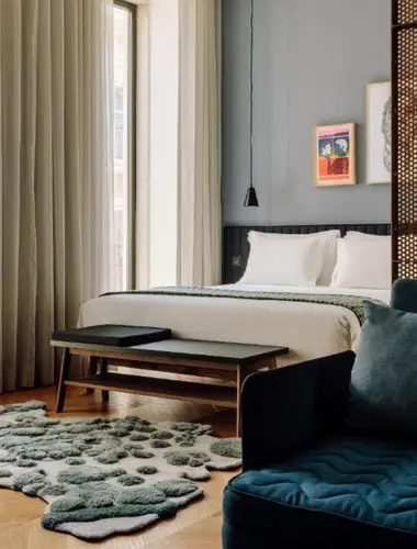 Guest room at Hotel Hotel Príncipe Real Lisbon with textured rug and framed artwork