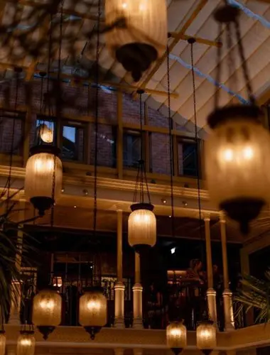 Nomad London restaurant atrium with Art Nouveau lanterns and glass ceiling