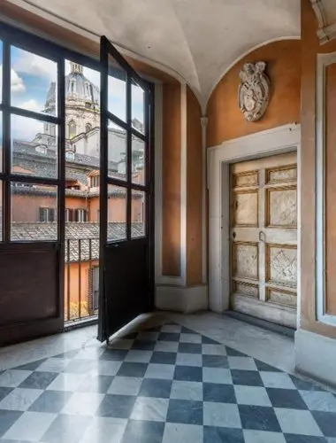 Light-filled interior with views over Rome’s historic rooftops at Hotel Dei Barbieri