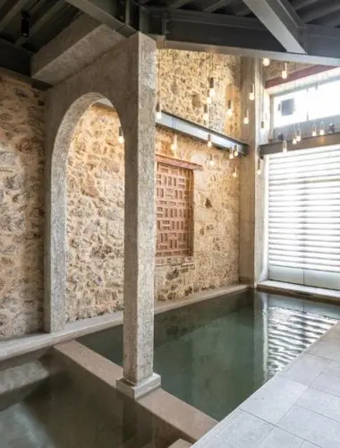 Indoor plunge pool set within a restored historic building at Asomaton, one of the most unique hotels with pools in Athens