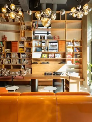 Social lounge and library space at Okupa, a community-focused hotel in Athens with a rooftop pool