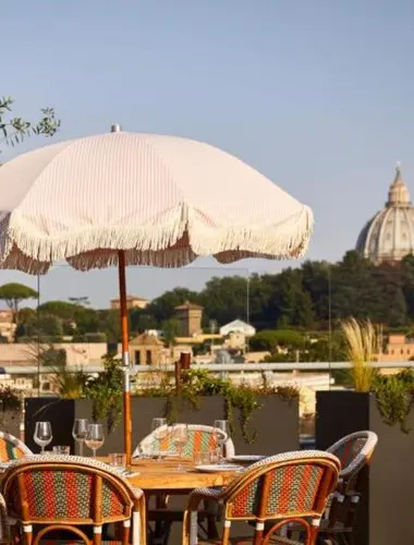 Rooftop restaurant terrace at Mama Shelter Roma with views across the Roman skyline