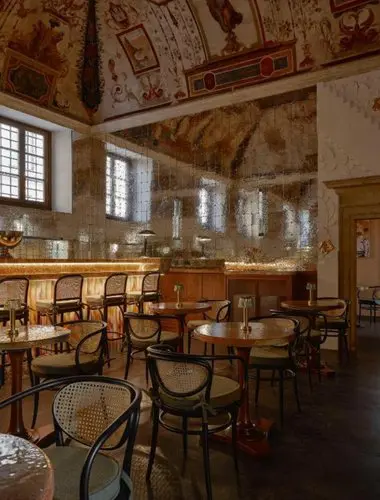 Atmospheric bar and lounge space inside Palazzo Talìa’s restored sixteenth-century palazzo