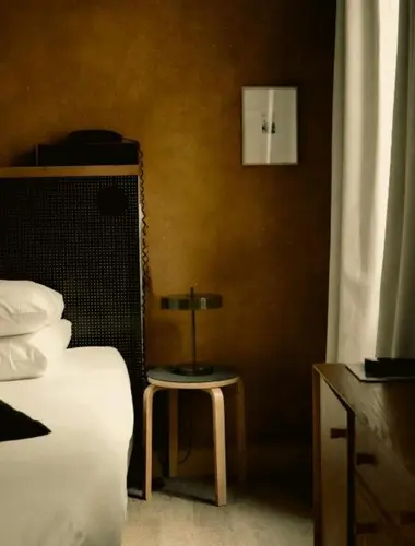 Earth-toned guest room at Hôtel La Nouvelle République, a contemporary spa hotel in Paris