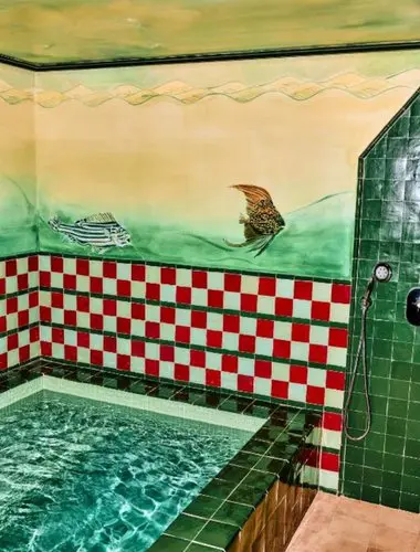 Spa pool with colourful tiled walls at Hôtel Les Deux Gares, a unique spa hotel in Paris